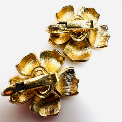 Close-up of Crown Trifari signature on vintage clip earrings.