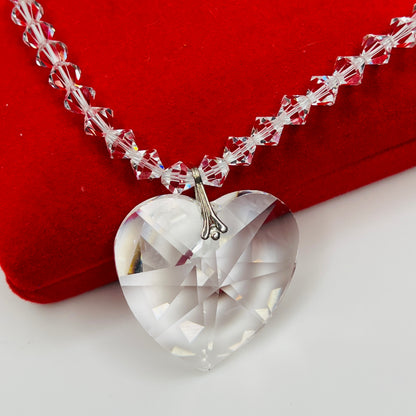 Close-up of vintage faceted crystal heart pendant on sparkling crystal bead necklace