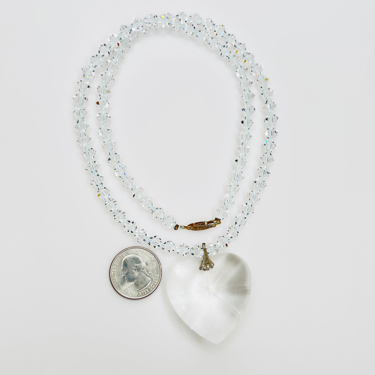 Close-up of vintage faceted crystal heart pendant on sparkling crystal bead necklace