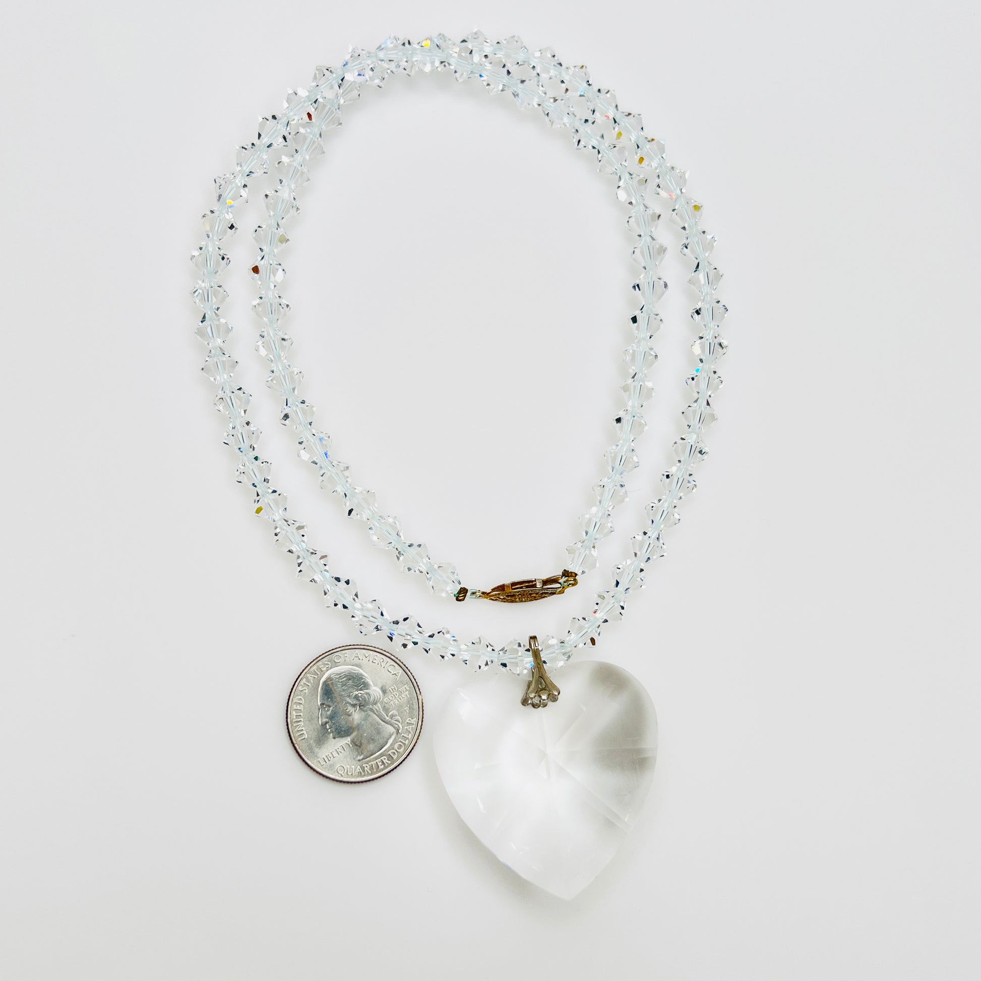 Close-up of vintage faceted crystal heart pendant on sparkling crystal bead necklace