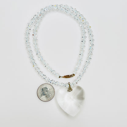 Close-up of vintage faceted crystal heart pendant on sparkling crystal bead necklace