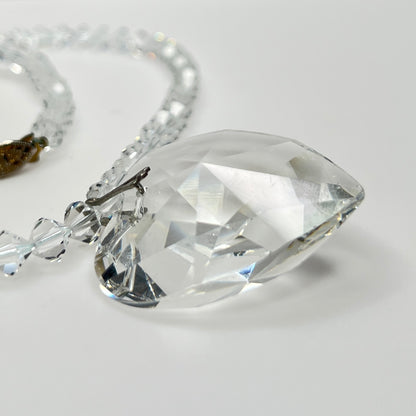 Close-up of vintage faceted crystal heart pendant on sparkling crystal bead necklace