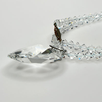 Side profile of large clear faceted crystal heart pendant necklace