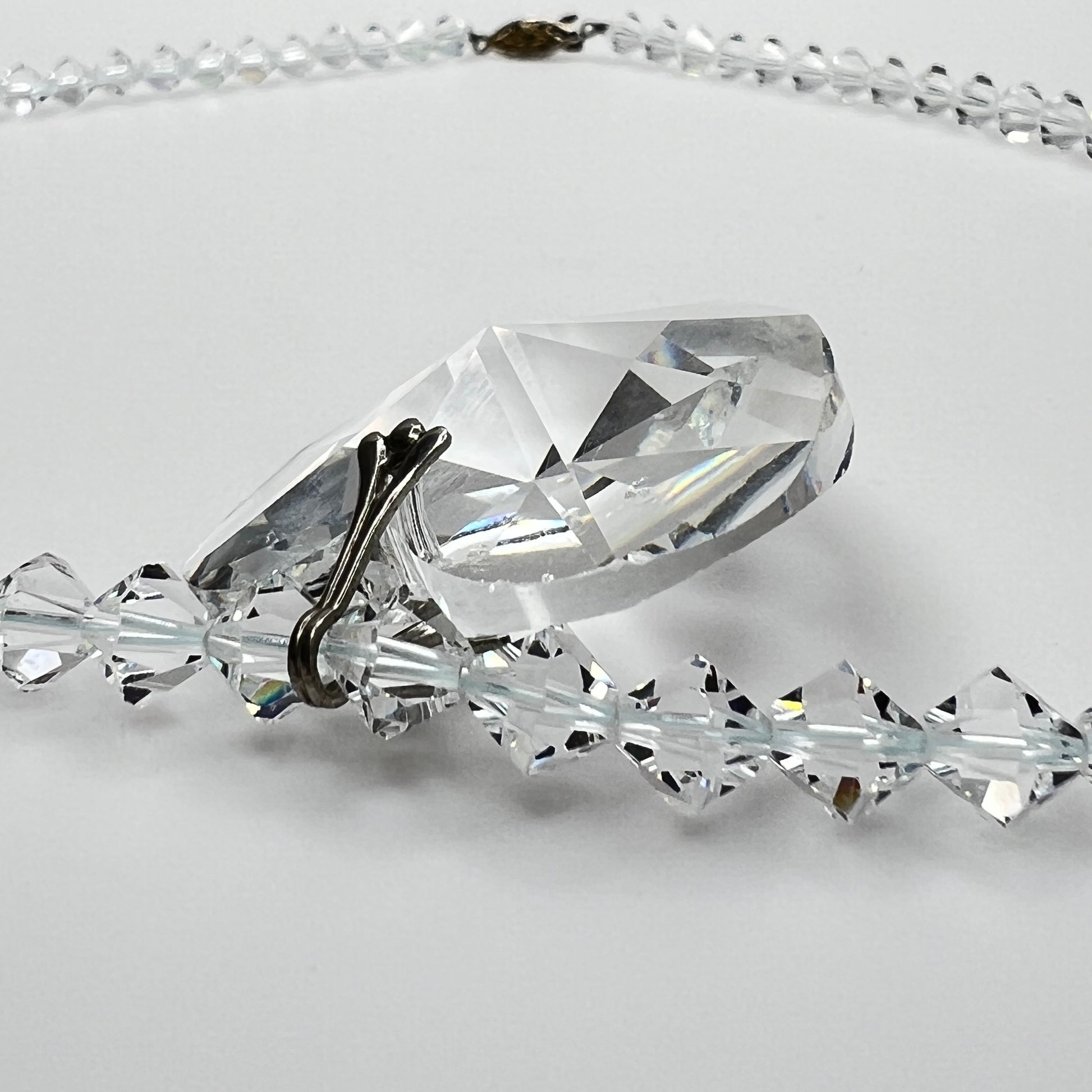 Close-up of vintage faceted crystal heart pendant on sparkling crystal bead necklace