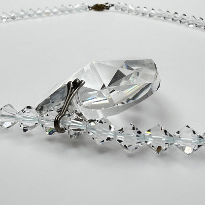 Close-up of vintage faceted crystal heart pendant on sparkling crystal bead necklace