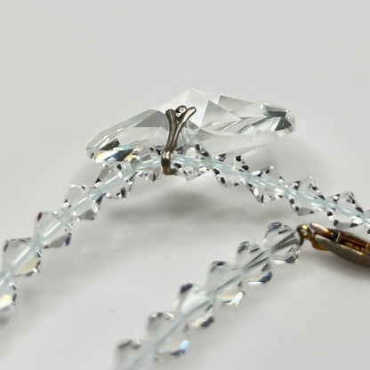 Close-up of vintage faceted crystal heart pendant on sparkling crystal bead necklace