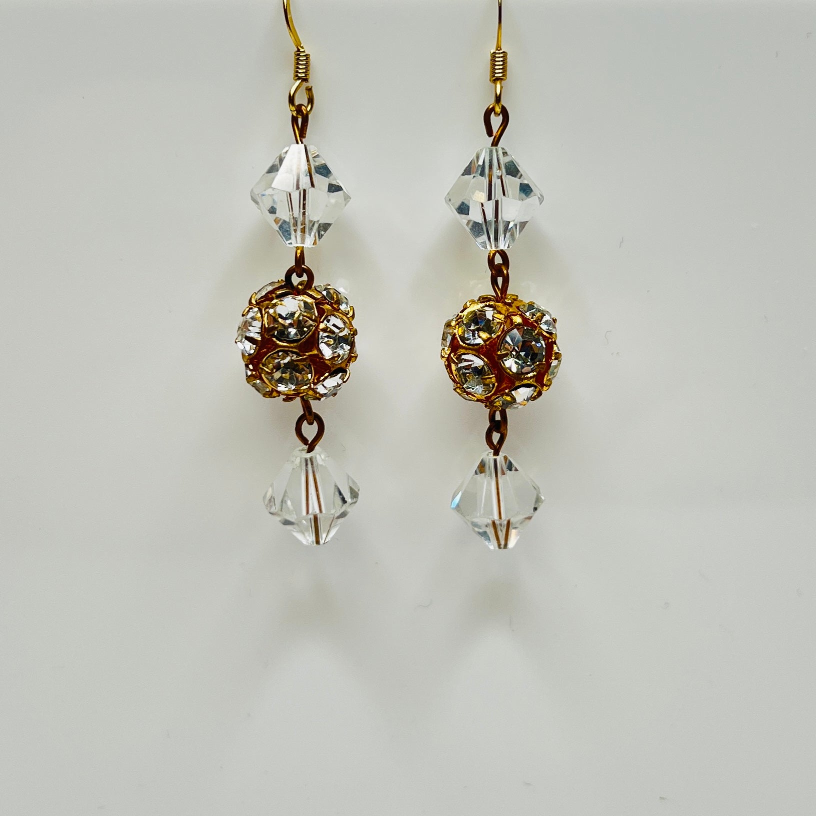 1960s crystal earrings with faceted glass and warm gold metal accents
