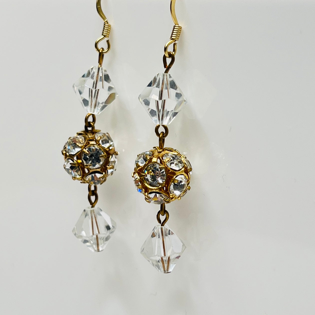 Close-up of clear vintage crystal drop earrings with sparkle detail
