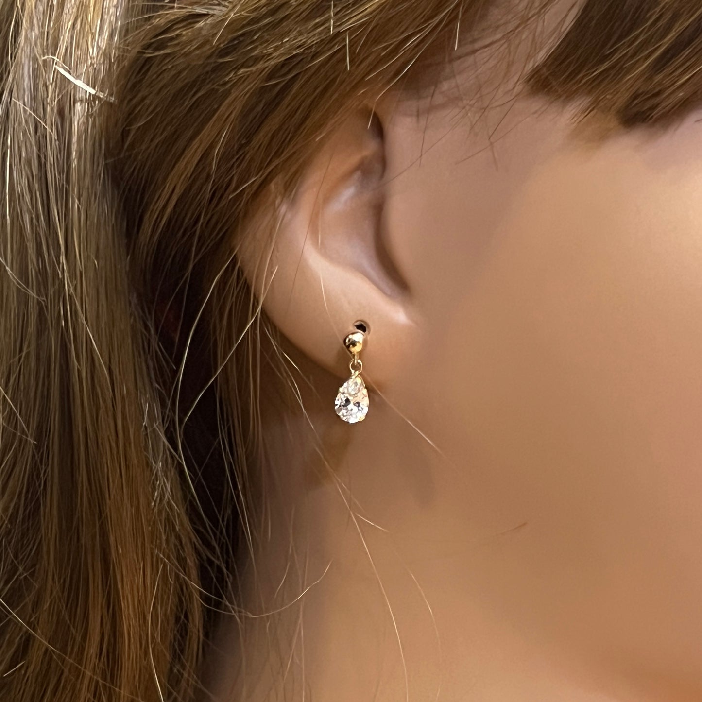 Gold-tone teardrop stud earrings with clear rhinestones and butterfly backs