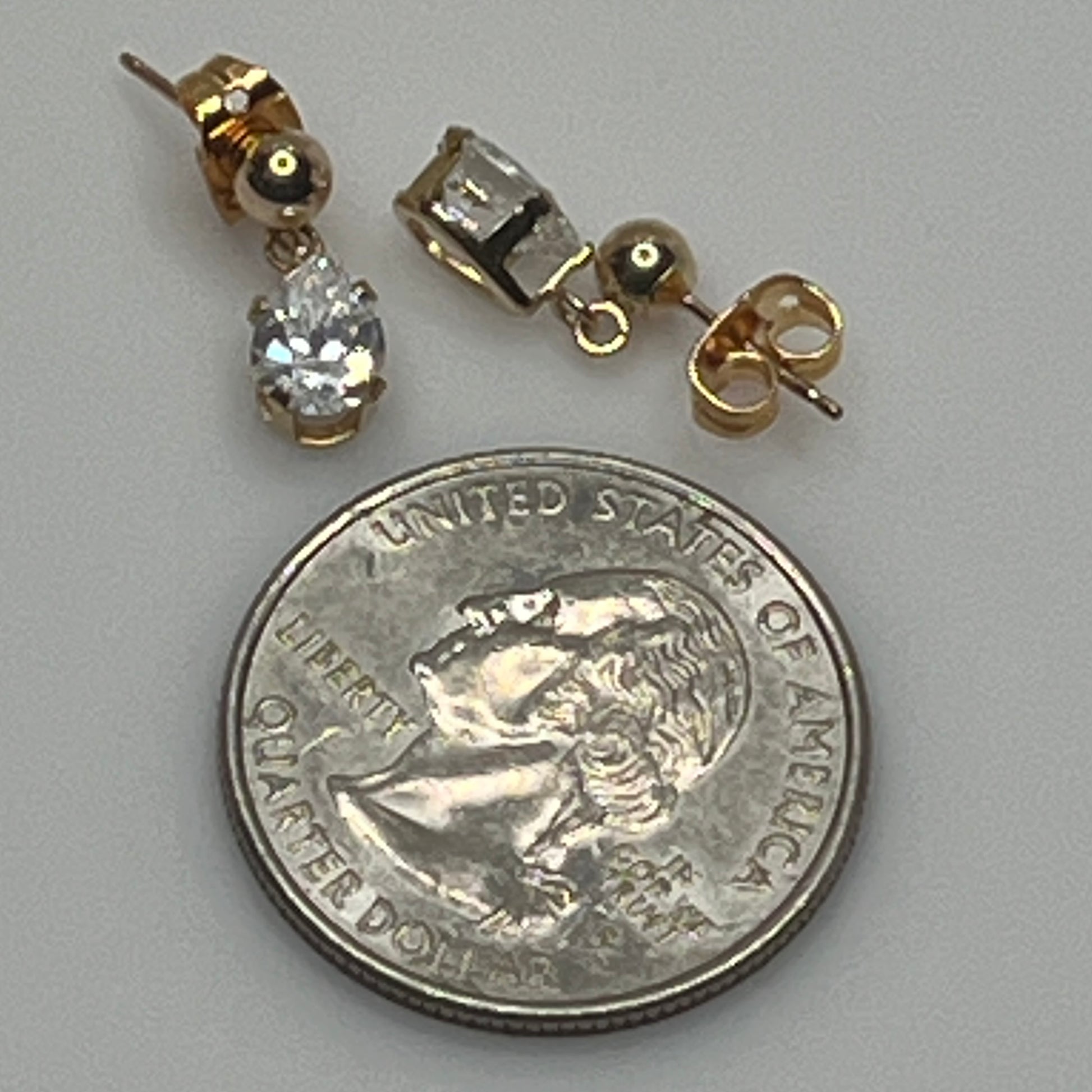 Gold-tone teardrop stud earrings with clear rhinestones and butterfly backs