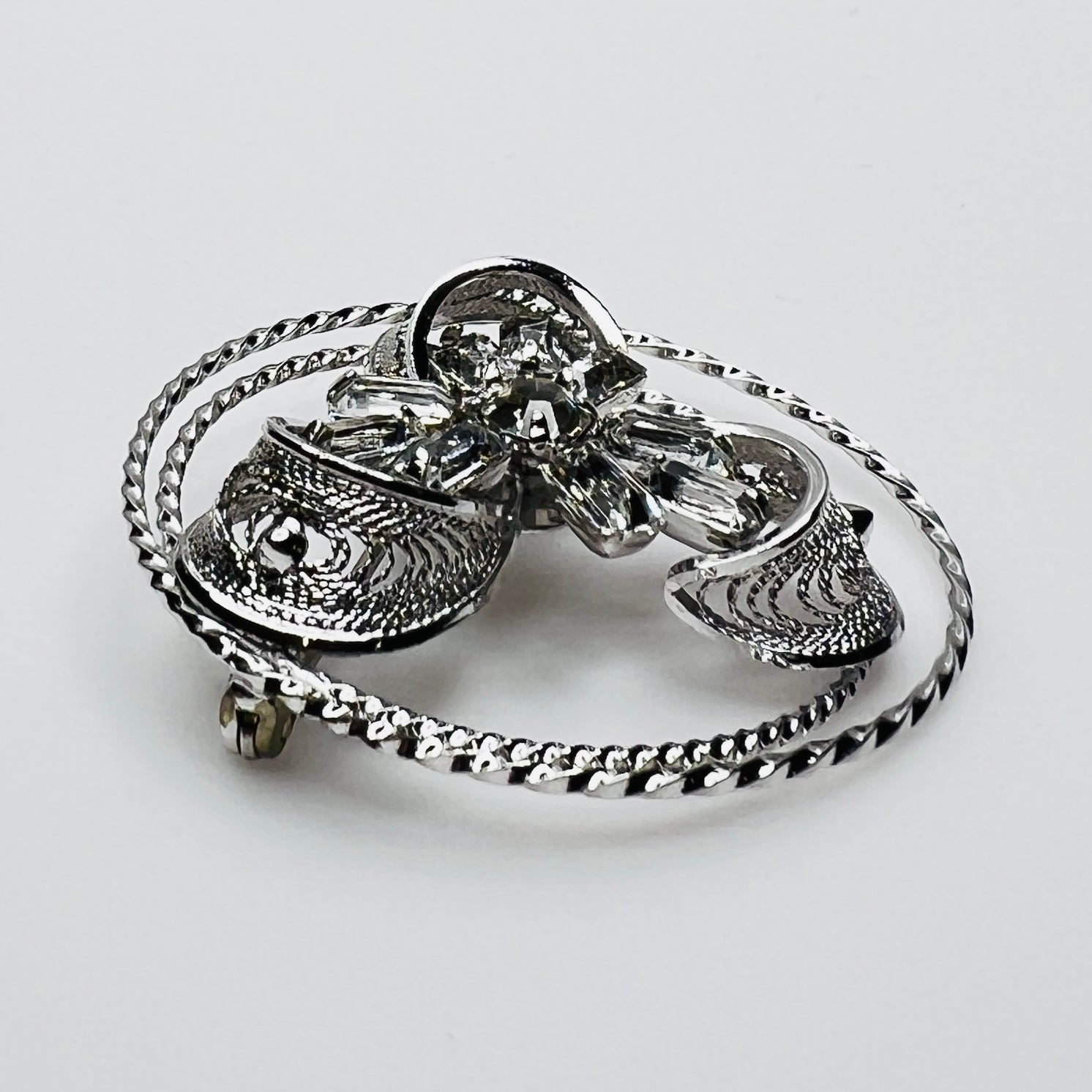 Side view showing dimensional crystal flower and silver loops