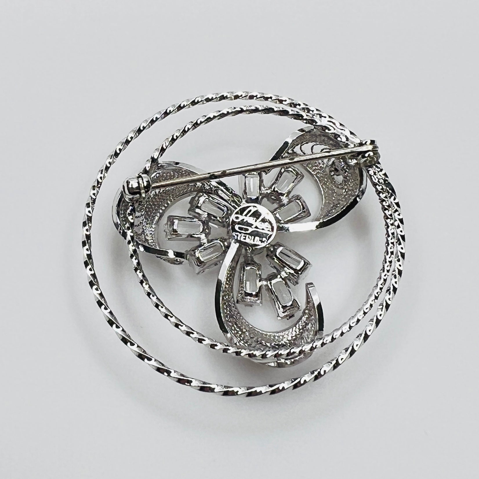 Back view showing dimensional crystal flower and silver loops