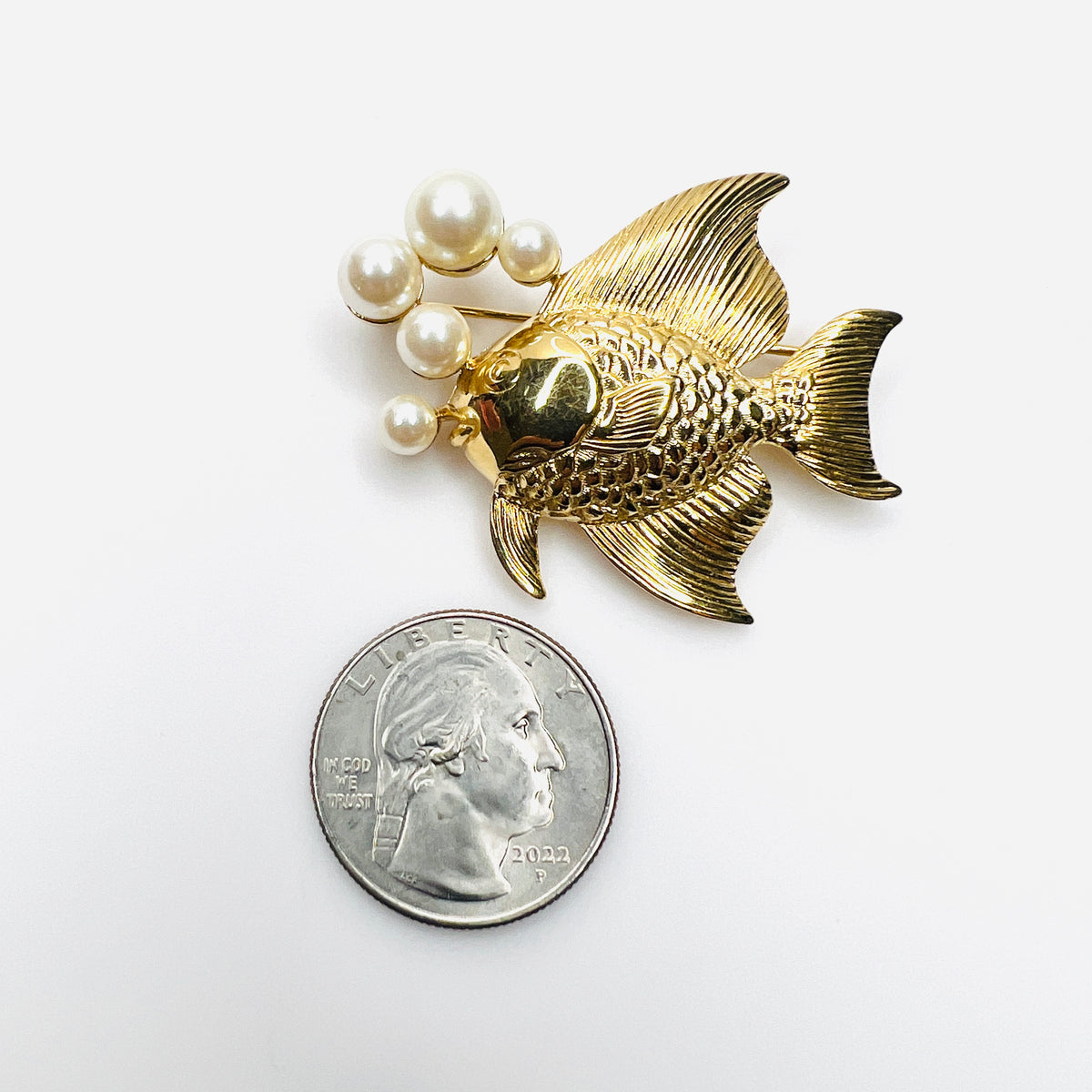 Gold fish and faux pearl bubble brooch shown beside quarter for scale
