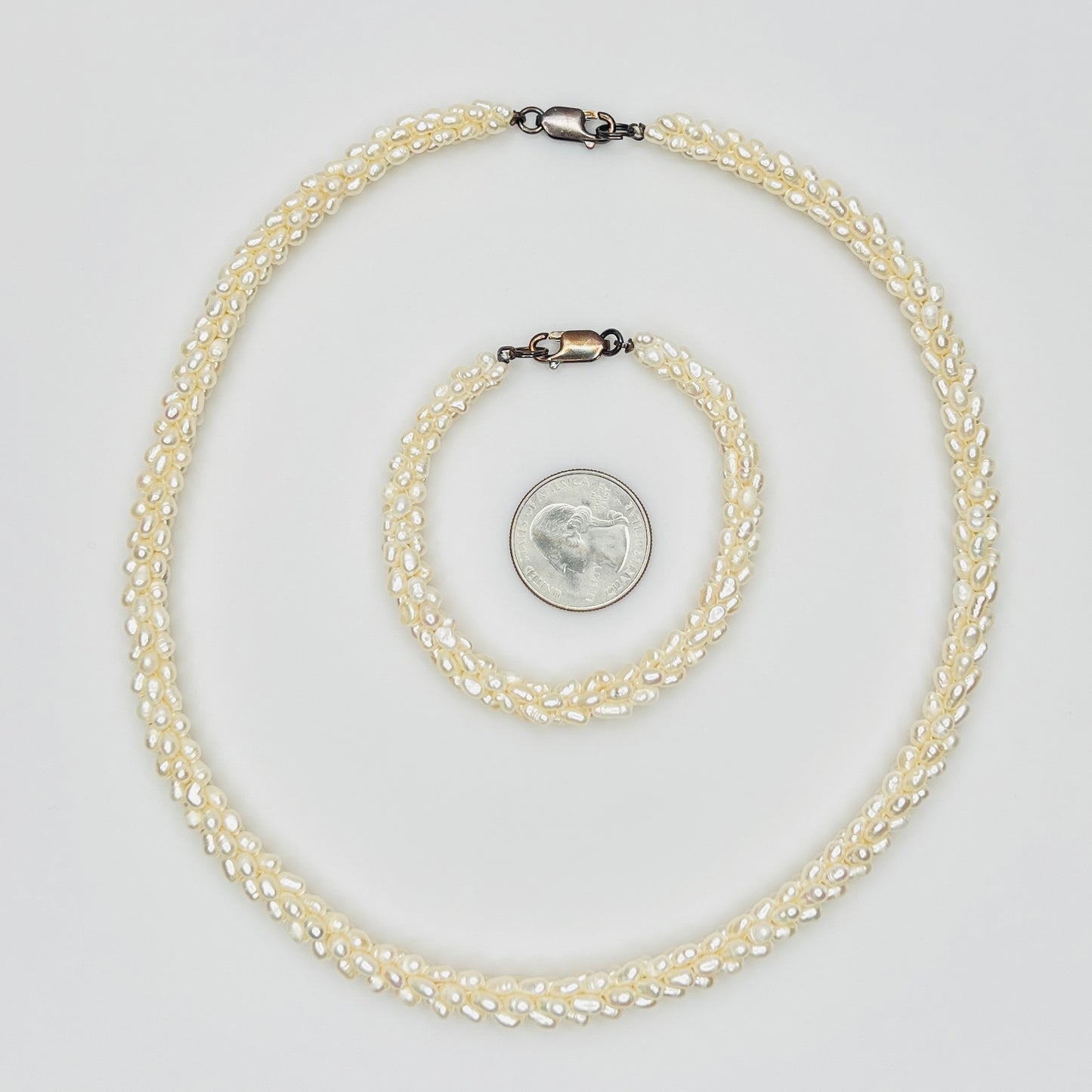 Pearl bracelet and necklace with quarter for size reference