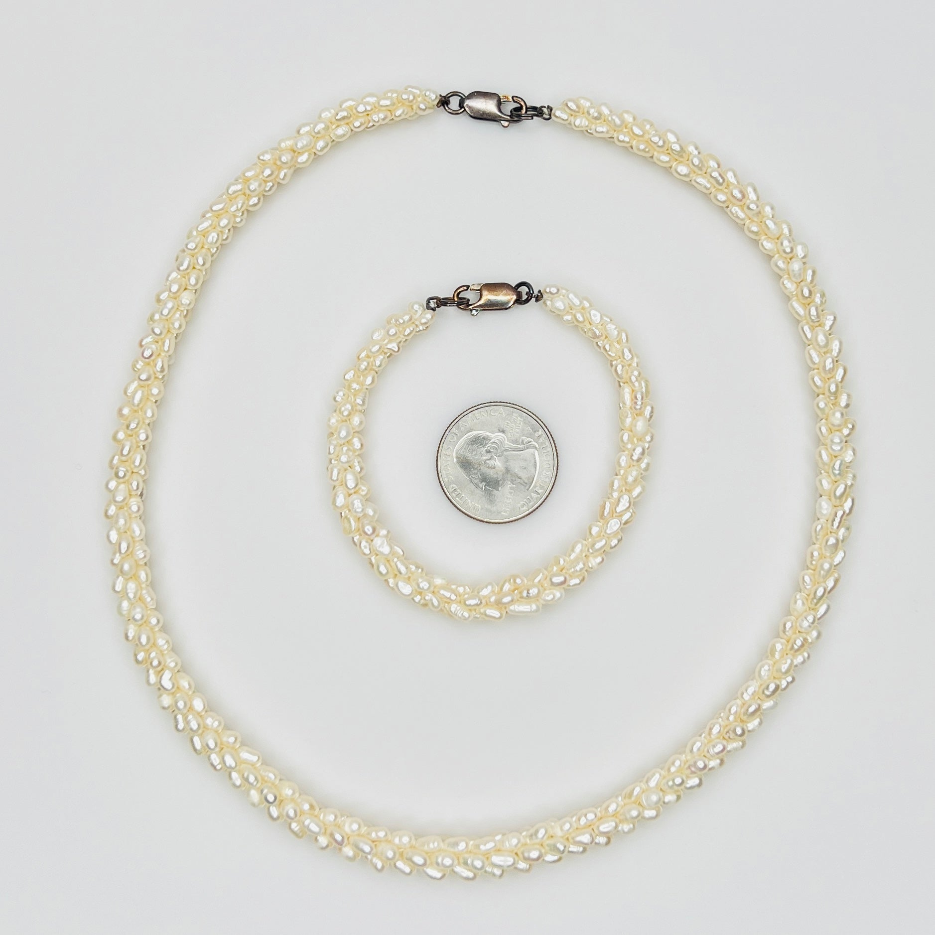 Pearl bracelet and necklace with quarter for size reference