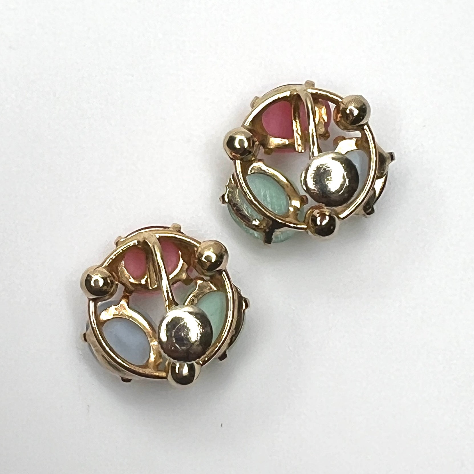 Back view of vintage fruit salad moonglow screw back earrings in gold tone metal