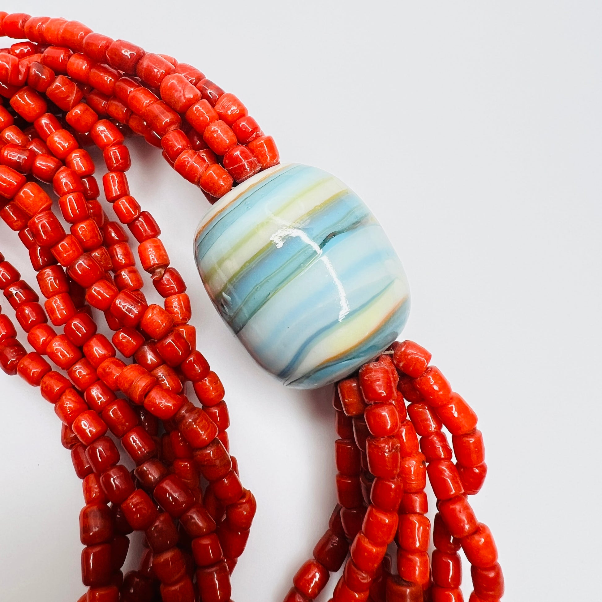 Large blue ceramic focal bead with red glass bead strands