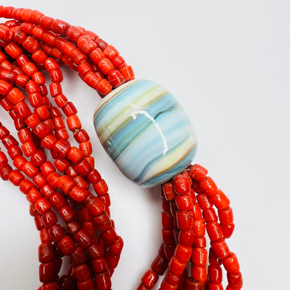 Large blue ceramic focal bead with red glass bead strands