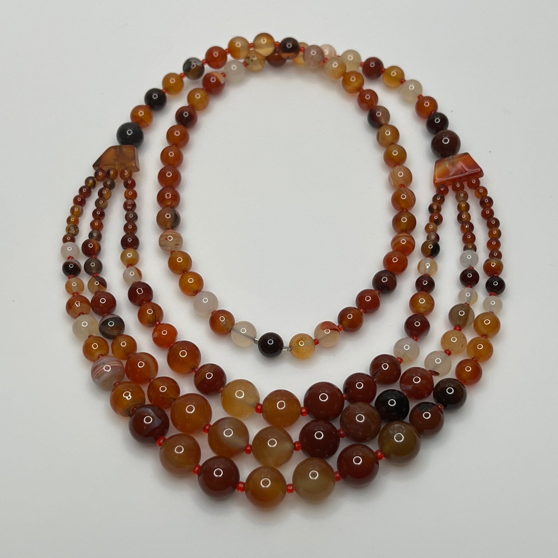 1960s-style over-the-head glass bead necklace with red and amber hues