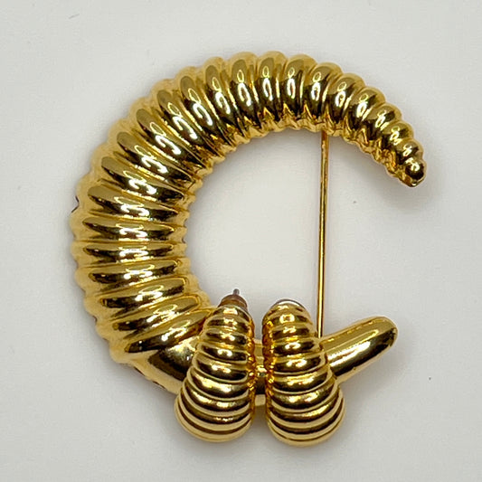 Vintage gold-tone crescent moon brooch with ribbed texture