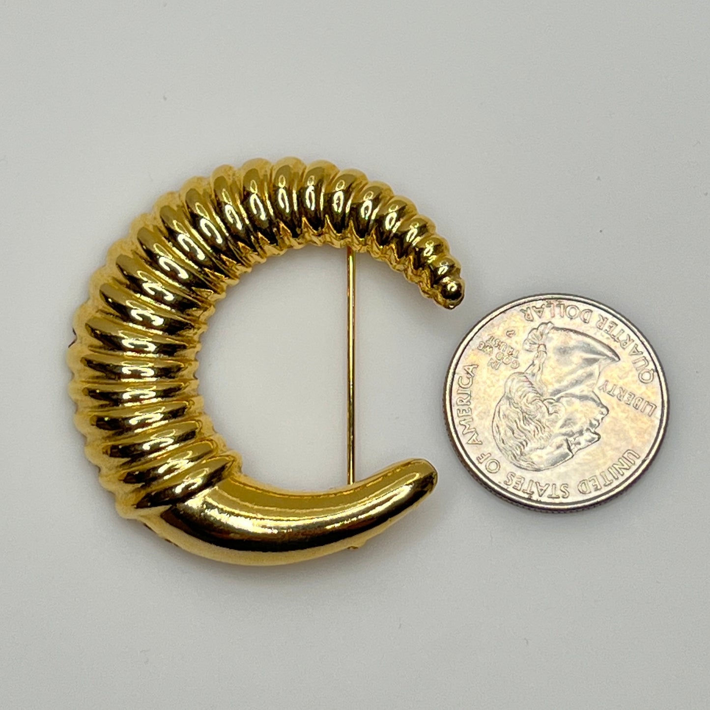 Vintage gold-tone crescent moon brooch with ribbed texture