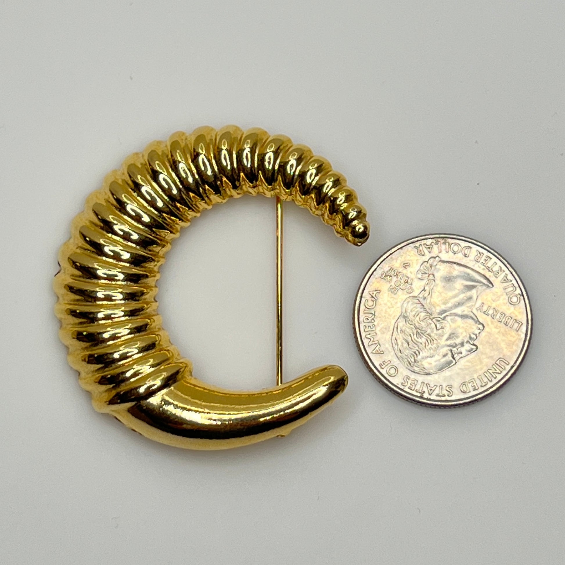 Vintage gold-tone crescent moon brooch with ribbed texture