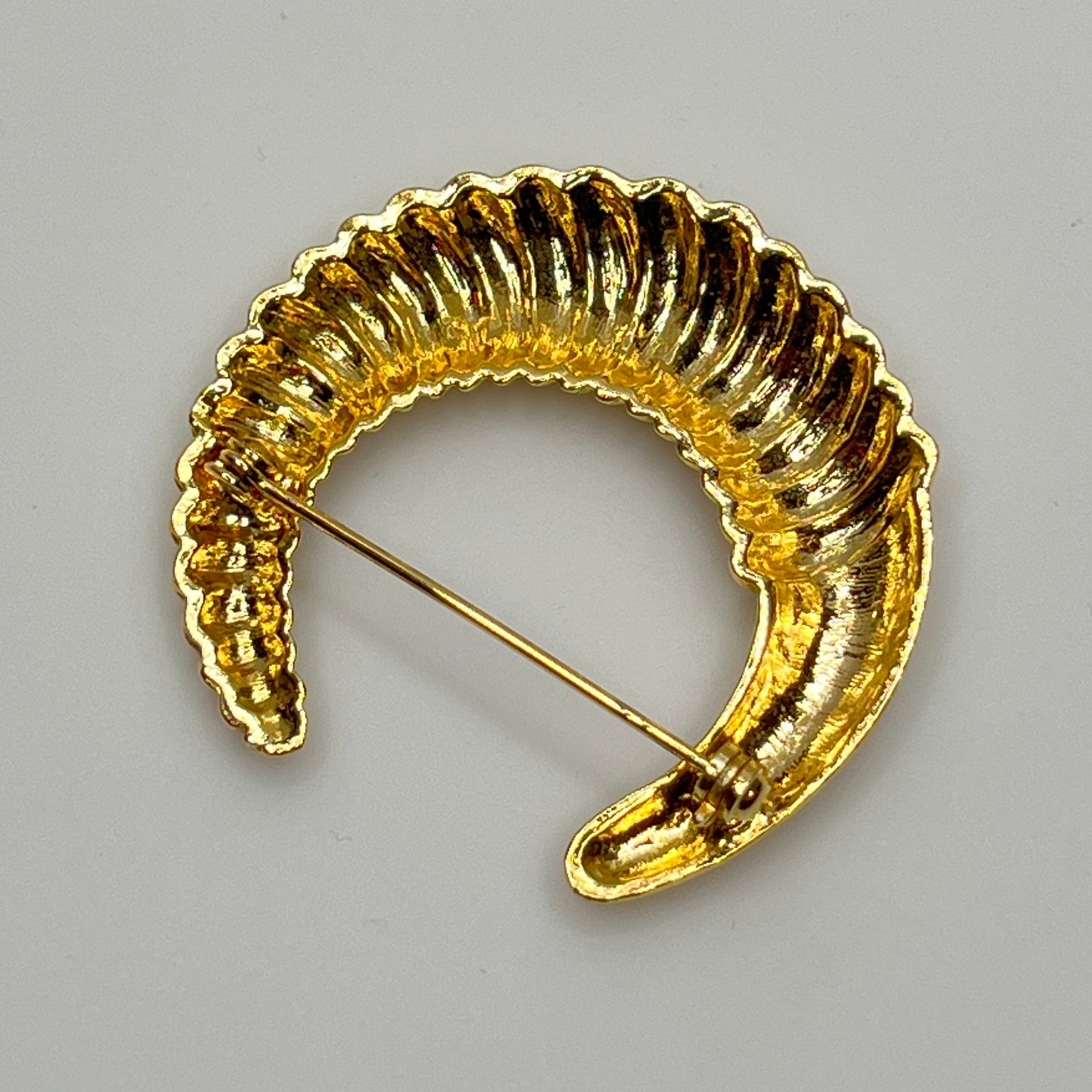 Vintage gold-tone crescent moon brooch with ribbed texture
