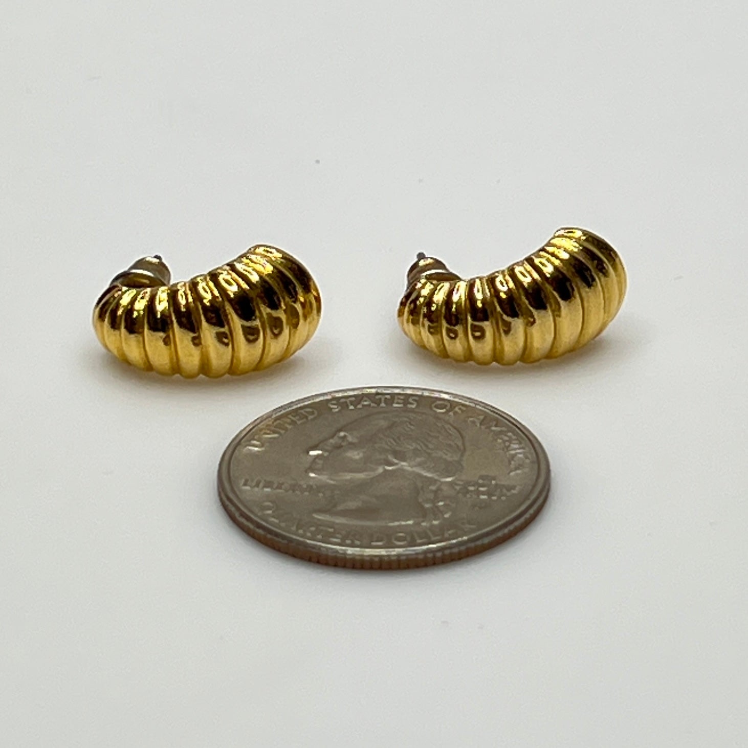 Matching crescent moon stud earrings in polished gold finish