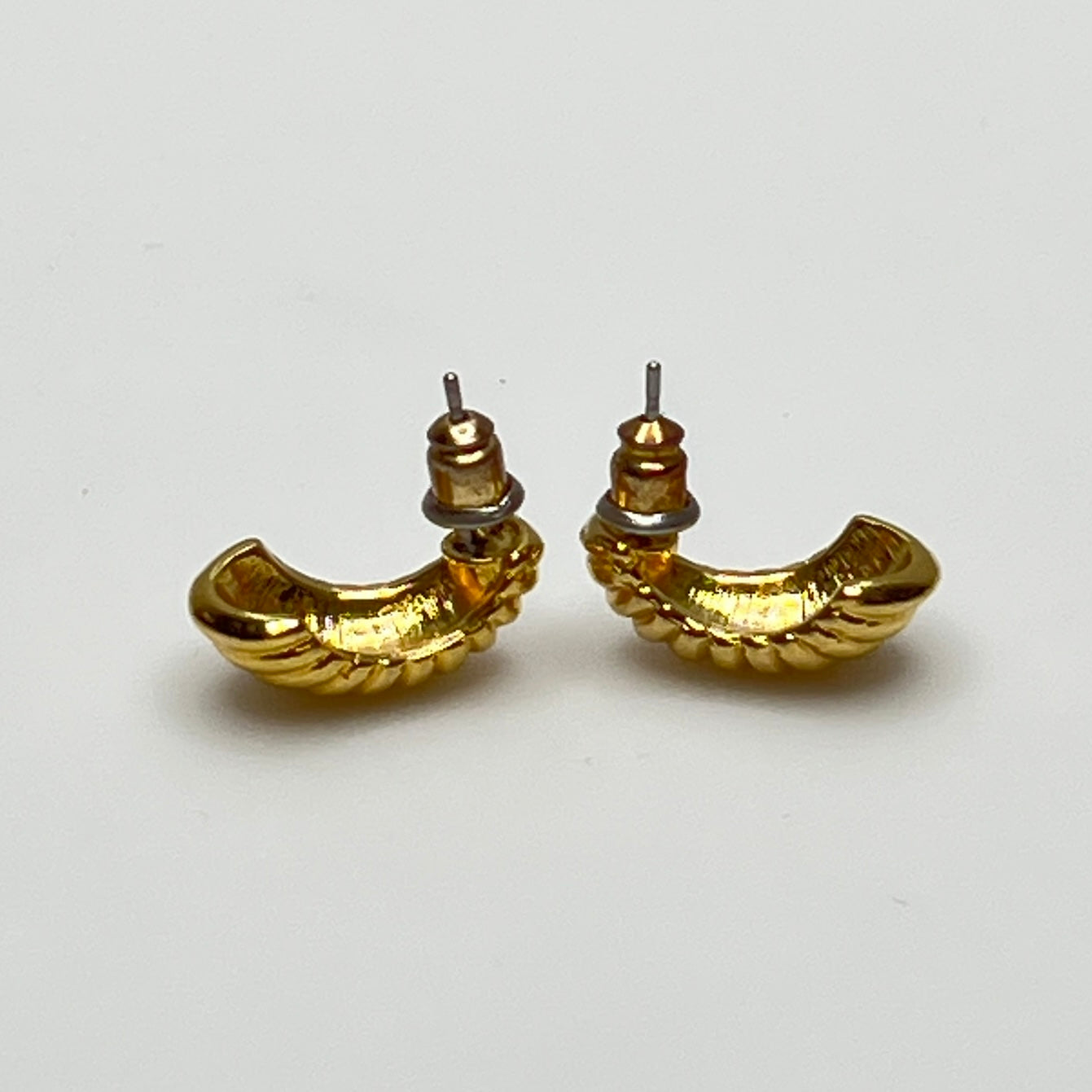 Matching crescent moon stud earrings in polished gold finish