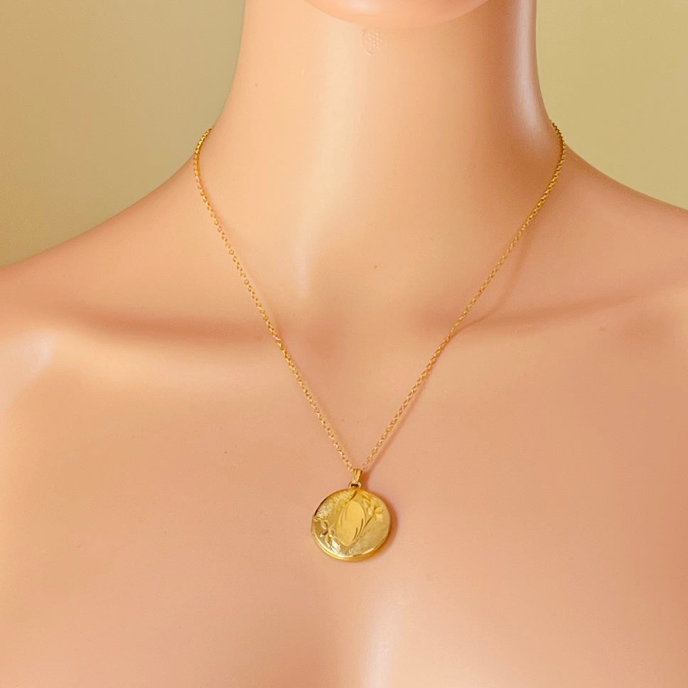 Gold locket necklace worn on mannequin 18 inch chain