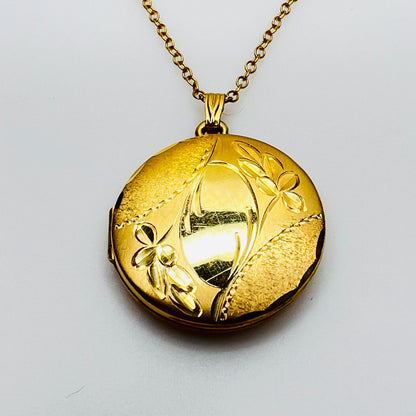 Close-up etched floral design H.F. Barrows gold locket