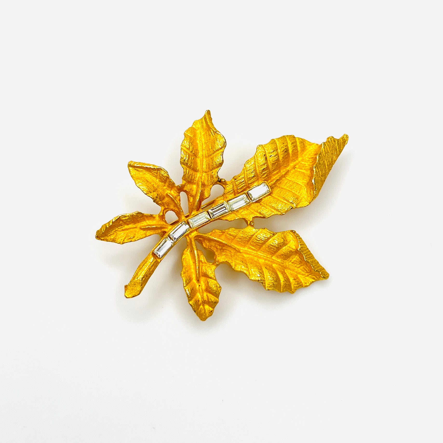 Vintage 1950s gold tone leaf brooch with clear baguette rhinestones