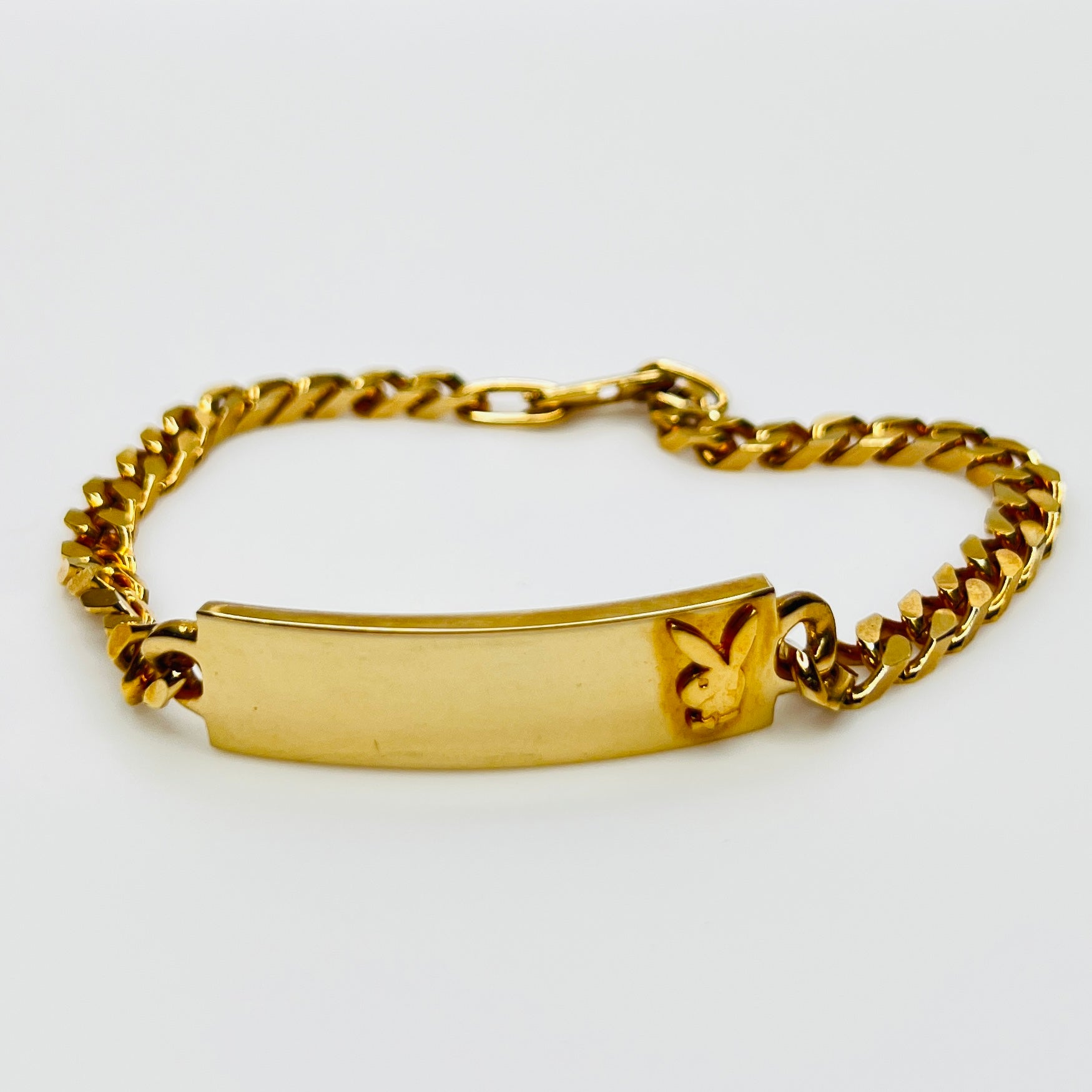 Gold tone chain bracelet with engraved Playboy Bunny plate