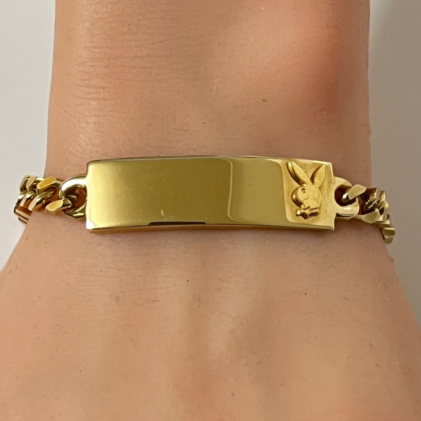 Vintage gold tone Playboy Bunny ID bracelet on wrist