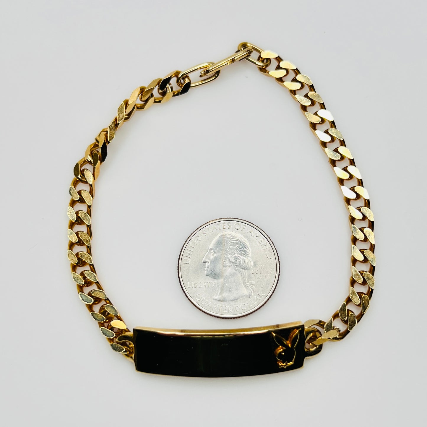 Gold tone chain bracelet with engraved Playboy Bunny plate
