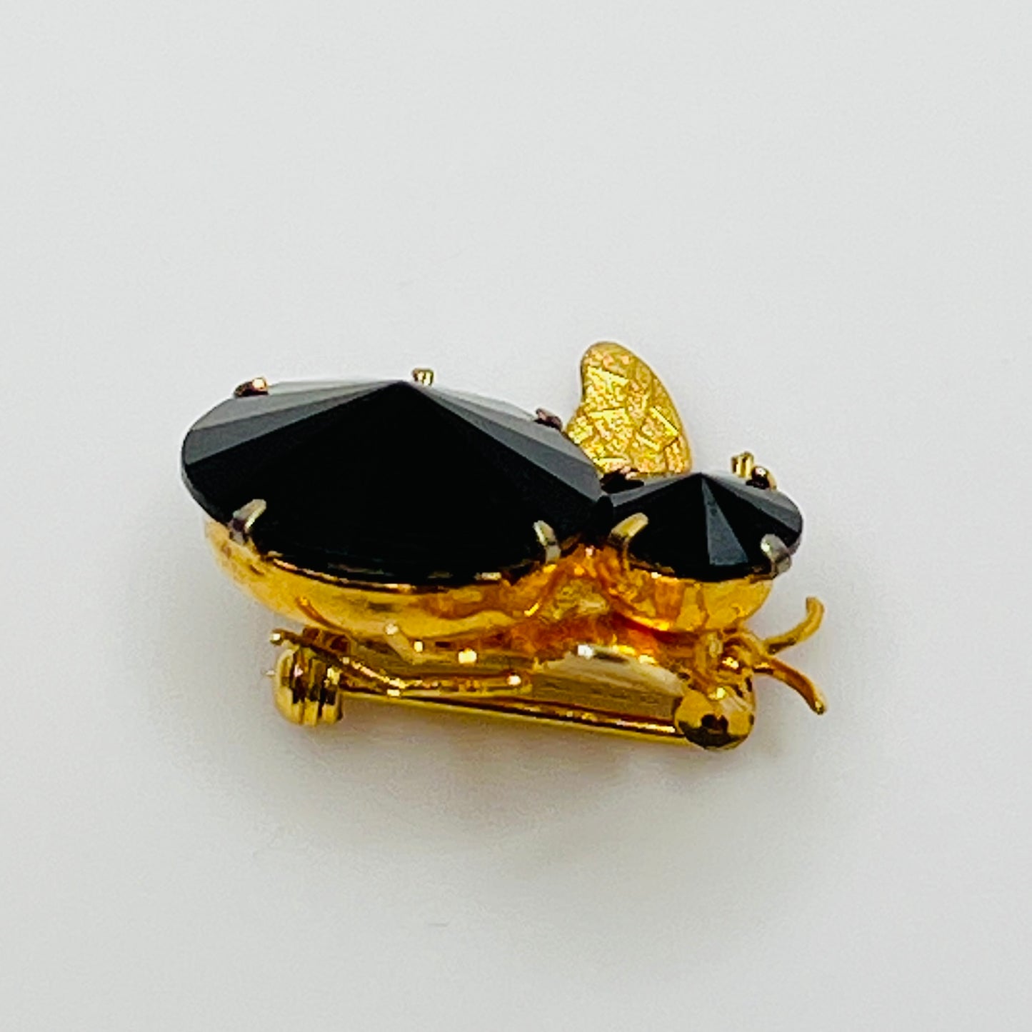 Gold-tone bee brooch with black faceted rhinestones, vintage insect pin