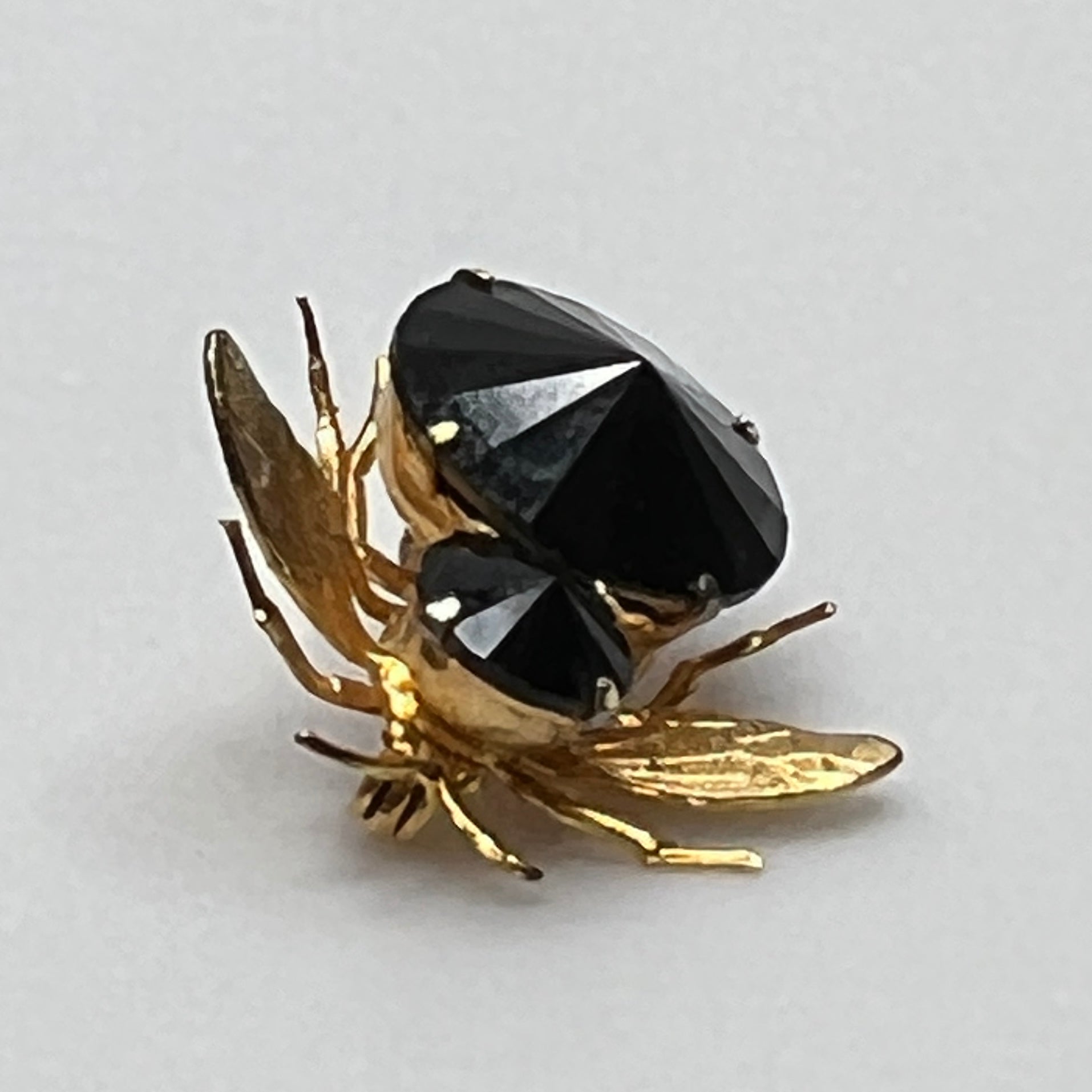 Gold-tone bee brooch with black faceted rhinestones, vintage insect pin