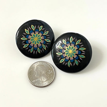 Matching hand-painted floral stud earrings in black, turquoise, blue, and gold enamel