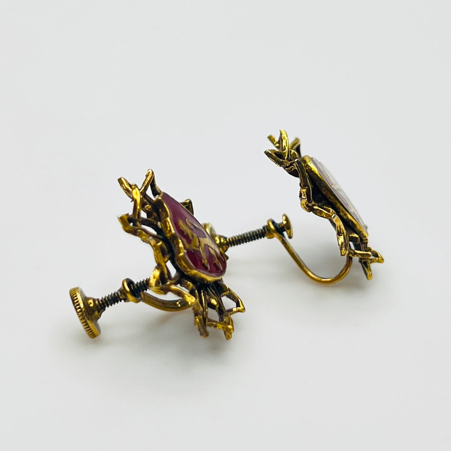 Side view of vintage heraldic screw back earrings