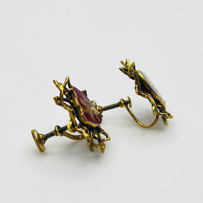 Side view of vintage heraldic screw back earrings