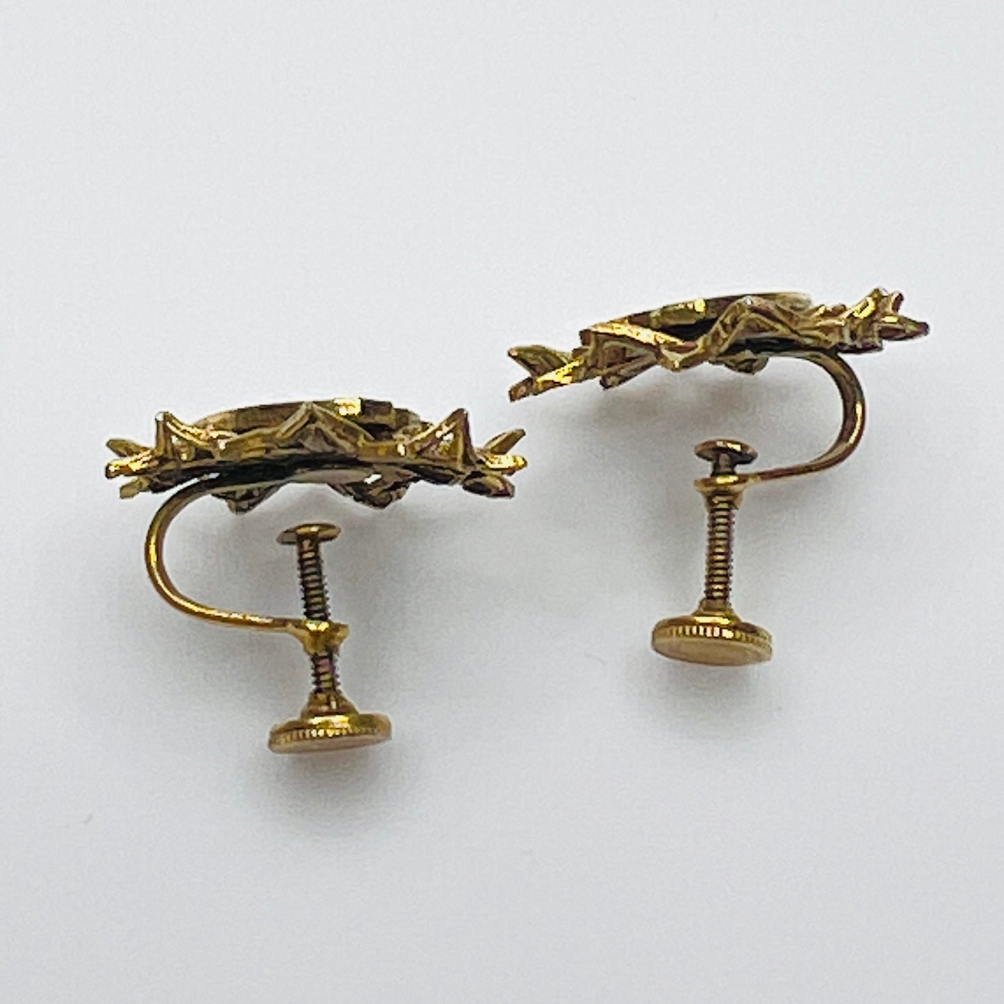 Side view of vintage heraldic screw back earrings