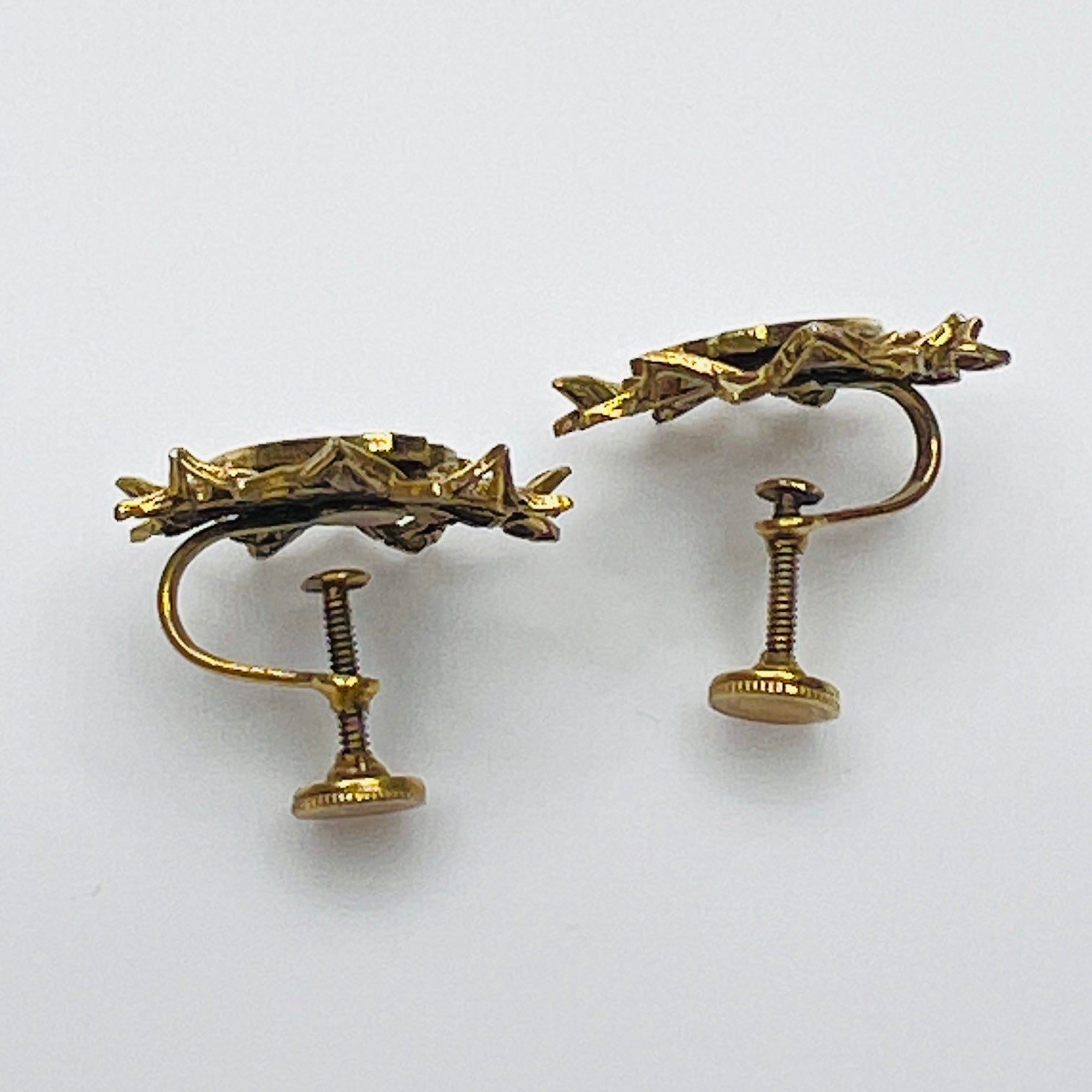 Side view of vintage heraldic screw back earrings