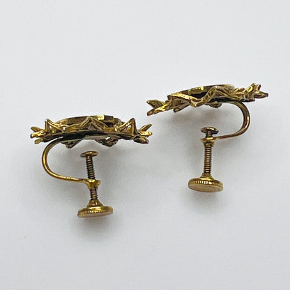 Side view of vintage heraldic screw back earrings