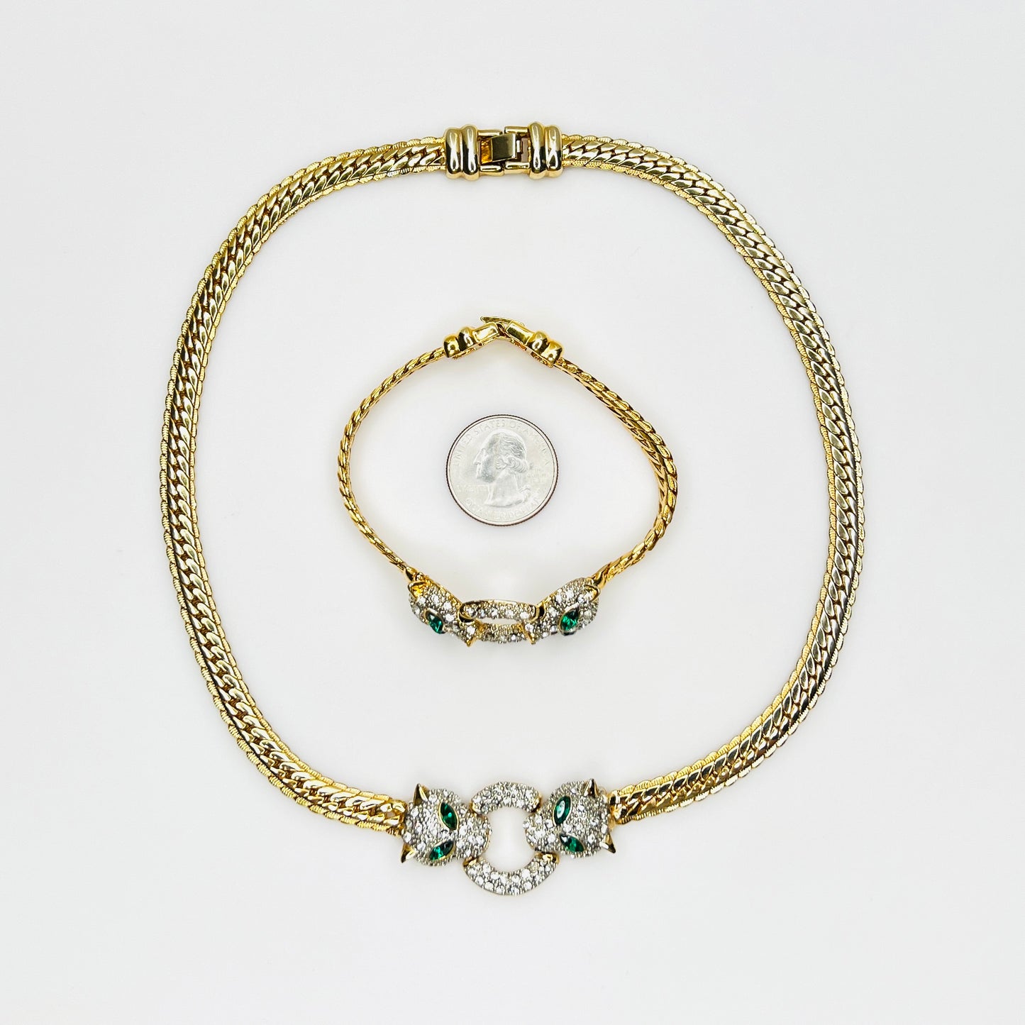 Vintage necklace and bracelet set with rhinestone panther heads and gold herringbone chains with quarter for scale