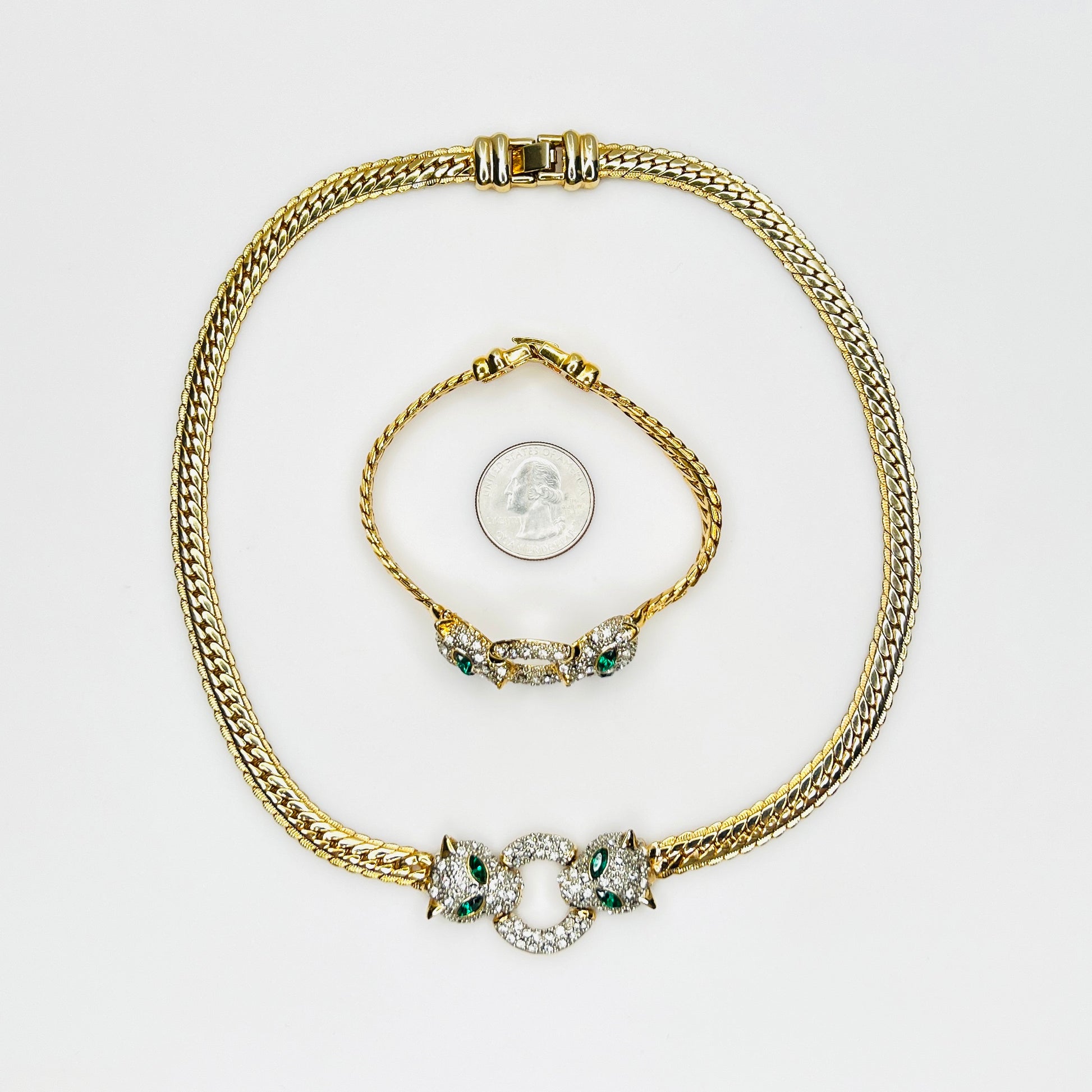 Vintage necklace and bracelet set with rhinestone panther heads and gold herringbone chains with quarter for scale