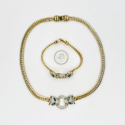 Vintage necklace and bracelet set with rhinestone panther heads and gold herringbone chains with quarter for scale