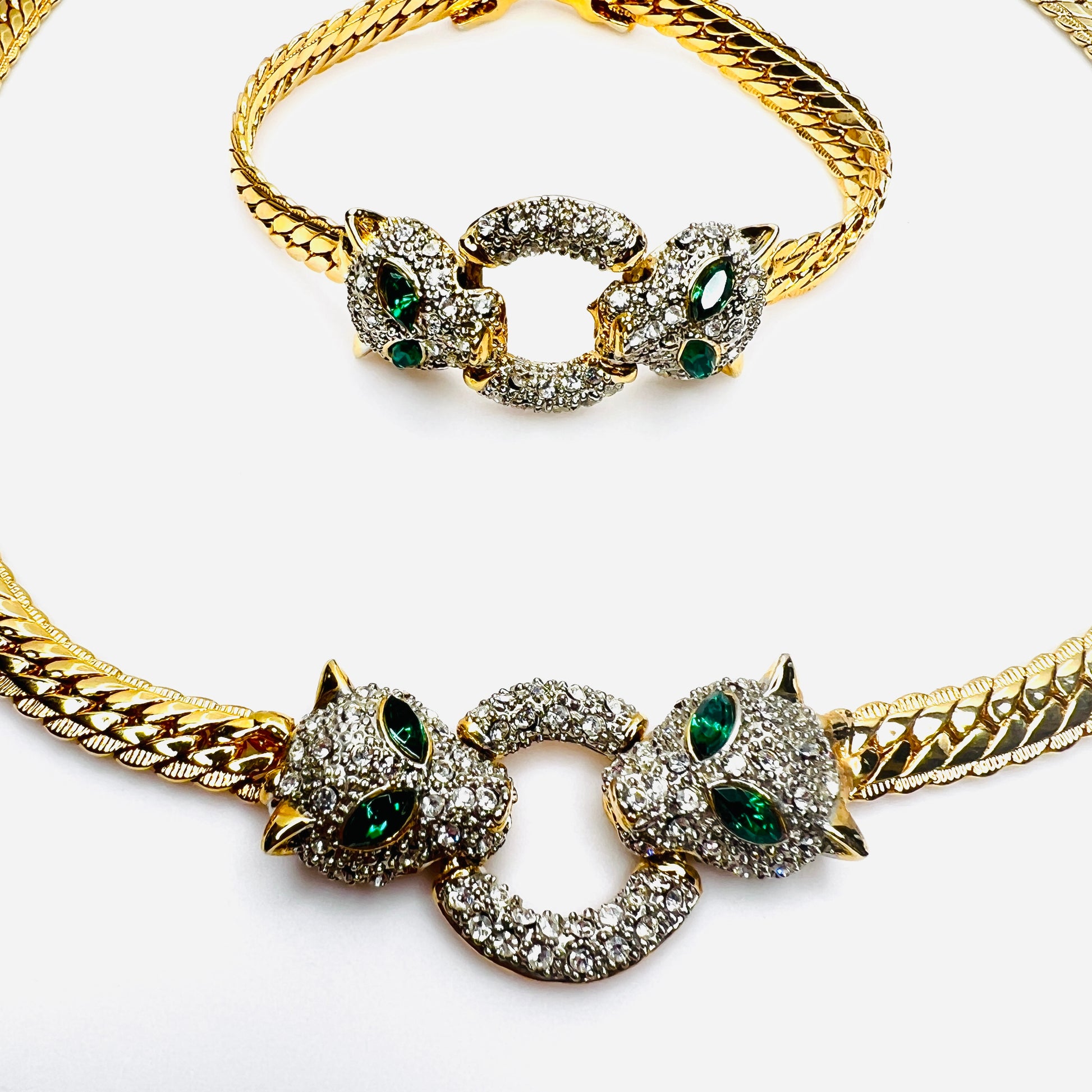 Close-up of rhinestone panther centerpiece with emerald green eyes on vintage jewelry set