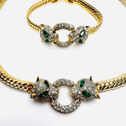 Close-up of rhinestone panther centerpiece with emerald green eyes on vintage jewelry set