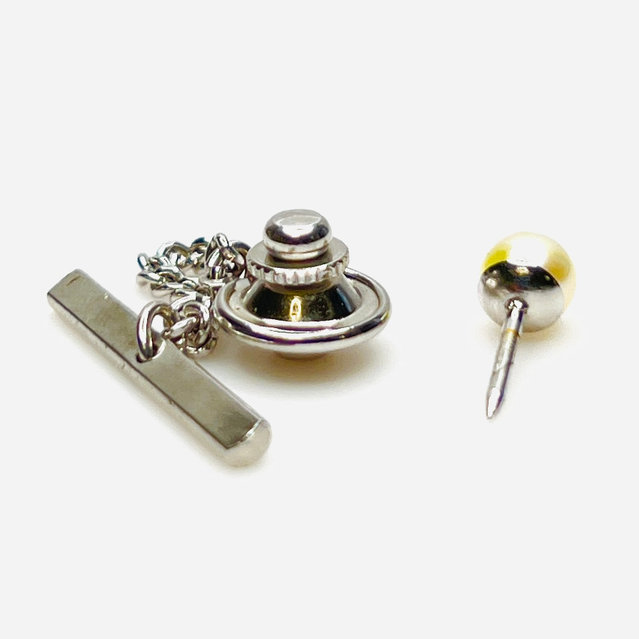 Vintage Hickok pearl tie tack showing chain and toggle fastening
