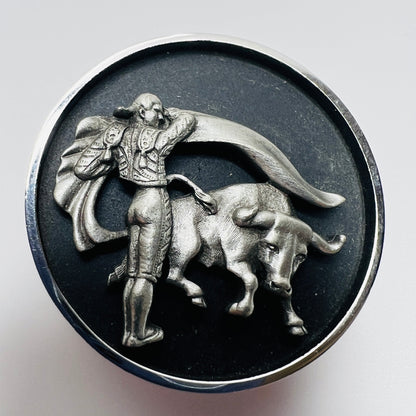 Round tie clip with raised matador and bull silver tone detail
